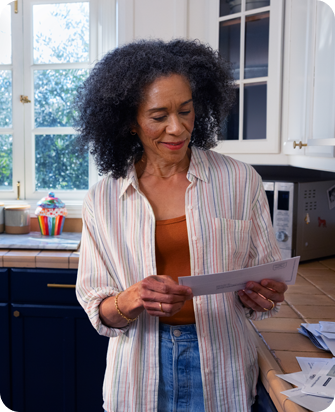 Actor portrayal of a postmenopausal woman reading her mail